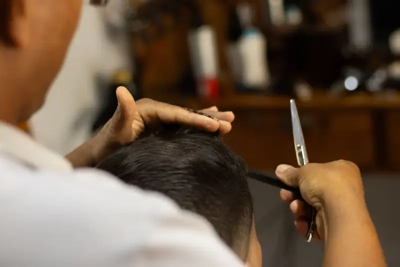 Barber cutting a client's hair in a classic barbershop