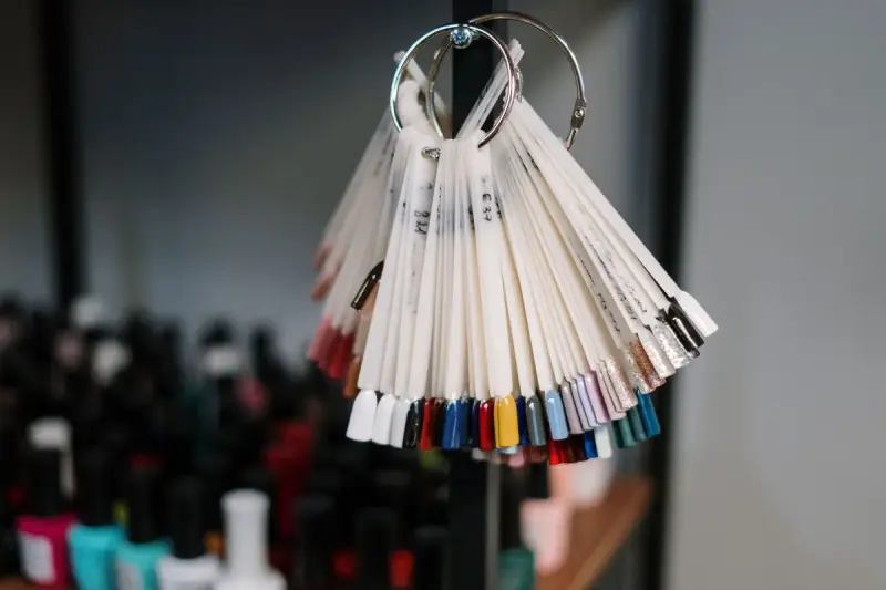 Nail polish swatch tips hanging in rows in a beauty salon