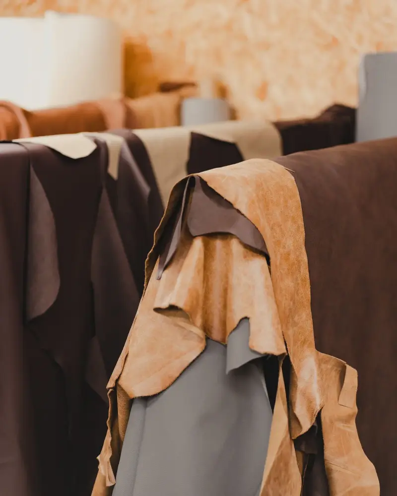 Tanned leather hides in brown and tan hanging indoors