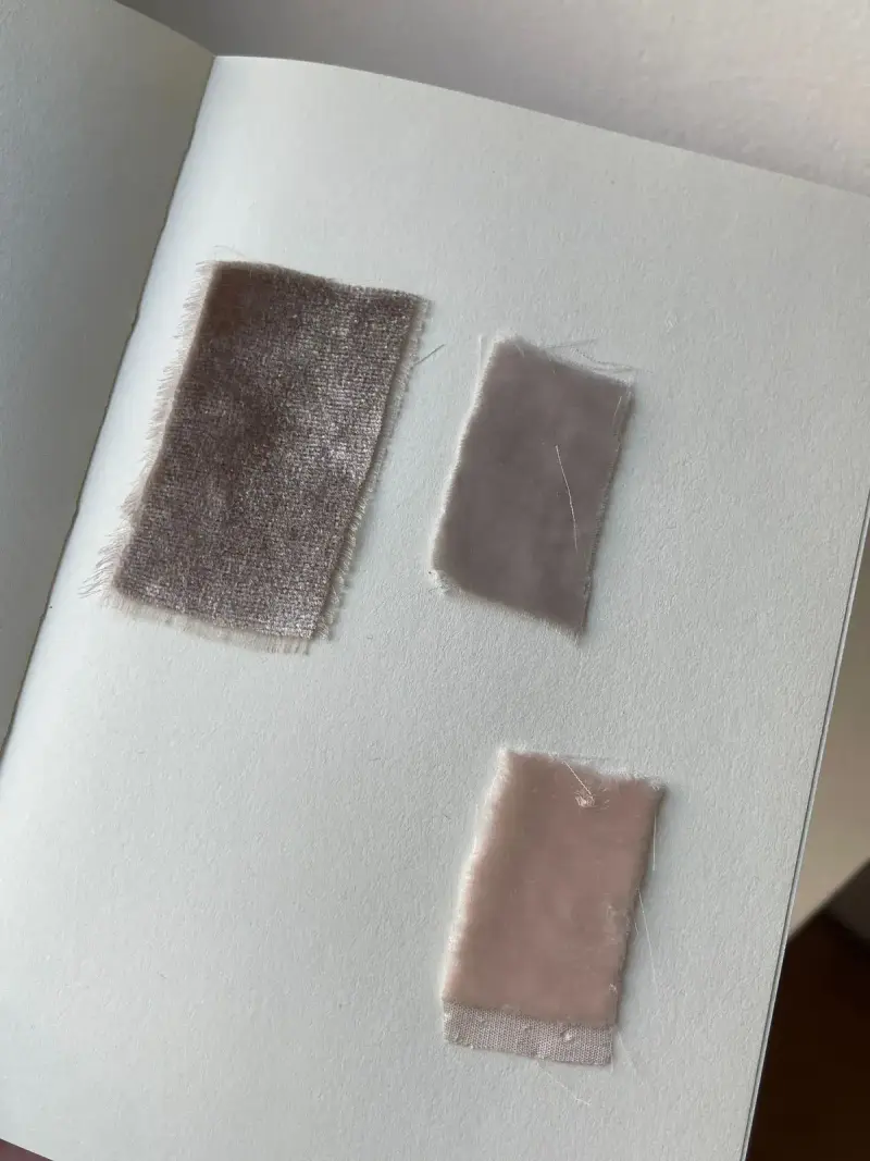 Taupe and blush velvet swatches pinned in a sample book
