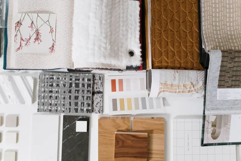 Flat lay of fabric, knit and color samples on a white board
