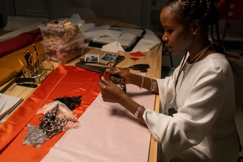 Fashion designer arranging fabric pieces on a cutting table
