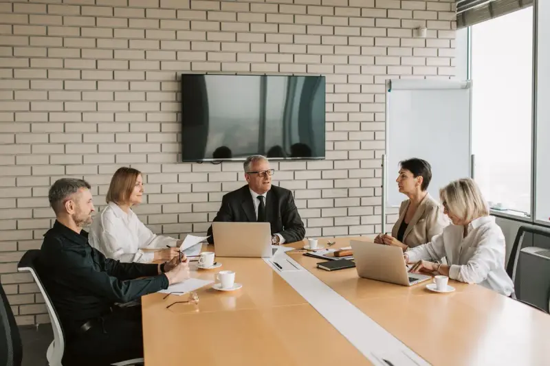 Team meeting with laptops and documents in a modern office