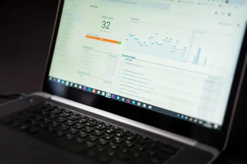 Laptop screen showing an analytics dashboard with charts and real-time numbers
