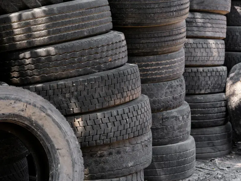 Stacks of worn truck tires piled for recycling