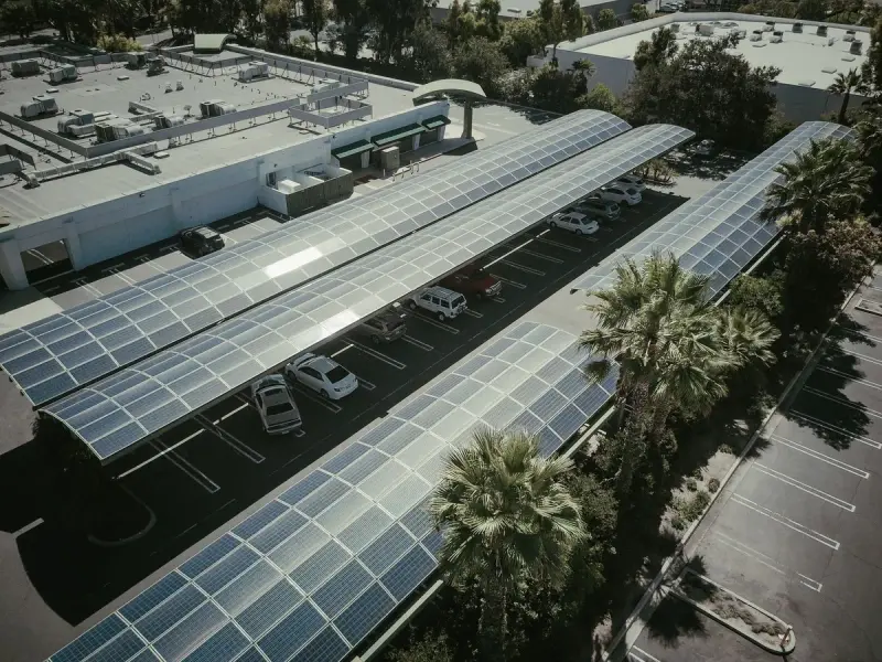 Aerial view of a parking lot covered by solar panel canopies
