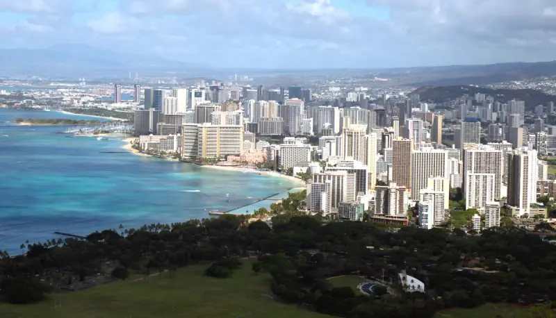 Waikiki's hotel towers and curving beach seen from the rim of Diamond Head, Honolulu