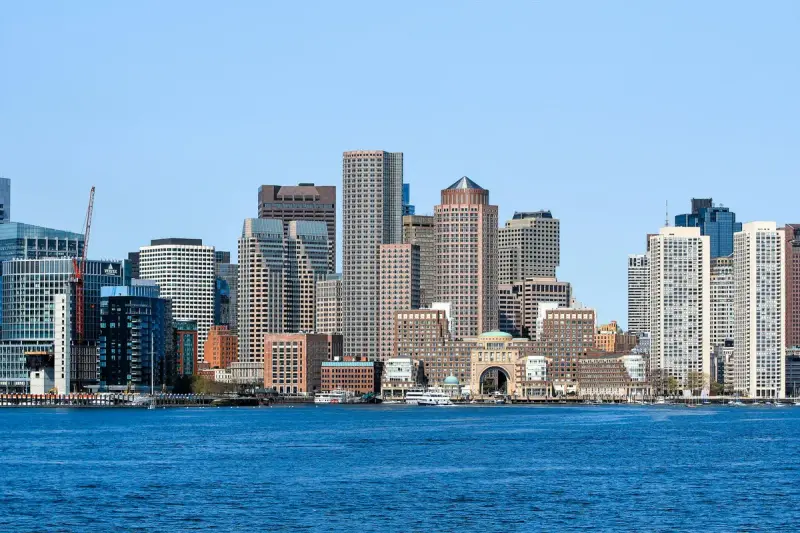 Boston skyline and waterfront under a clear blue sky