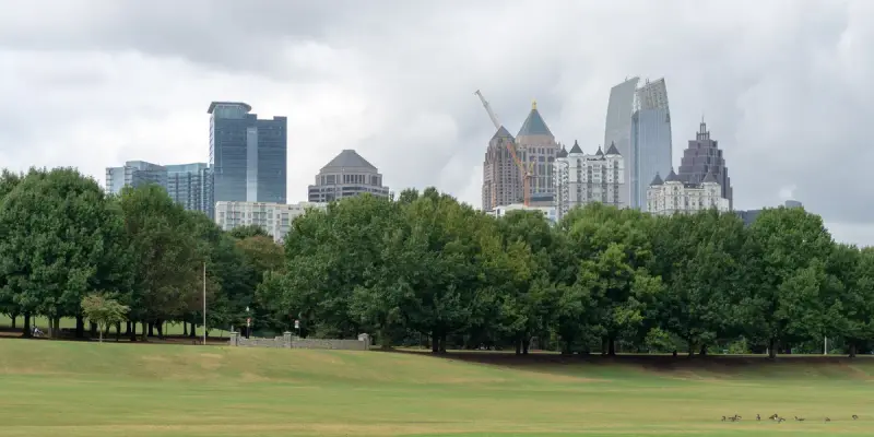 Atlanta's Midtown skyline seen across the green lawns and trees of Piedmont Park
