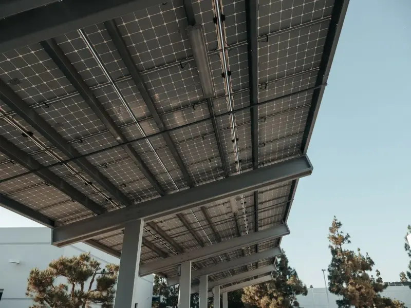 Low-angle view of solar panels on a frame under a clear sky