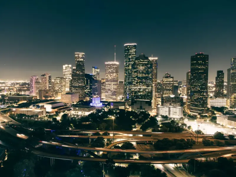 Aerial night view of the Houston skyline with lit highways