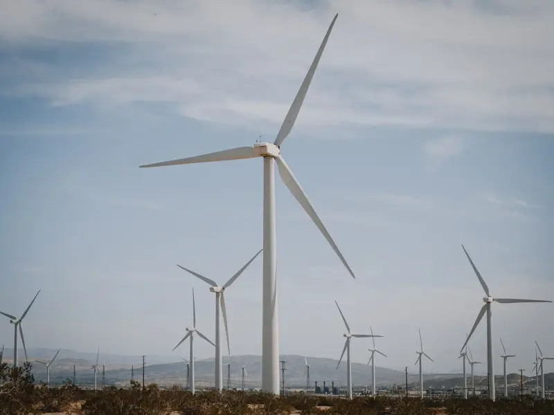 Wind turbines on dry brown grassland under a wide sky