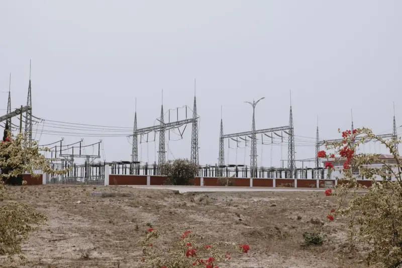 Electrical substation with steel structures and power lines in a dry landscape