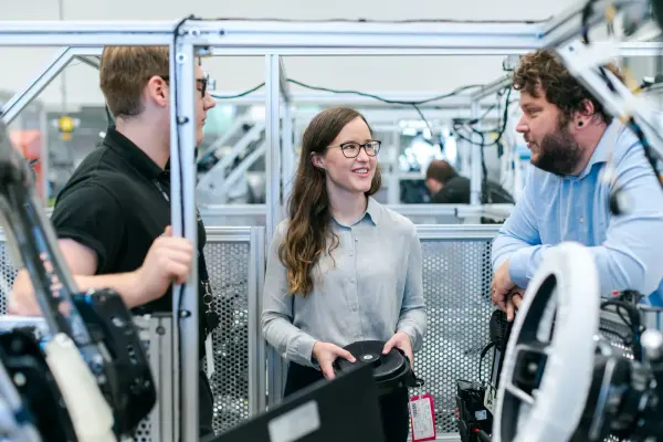 Engineers collaborating in an automotive workshop