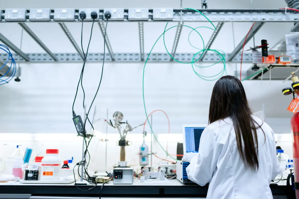 Female researcher working among instruments in a laboratory