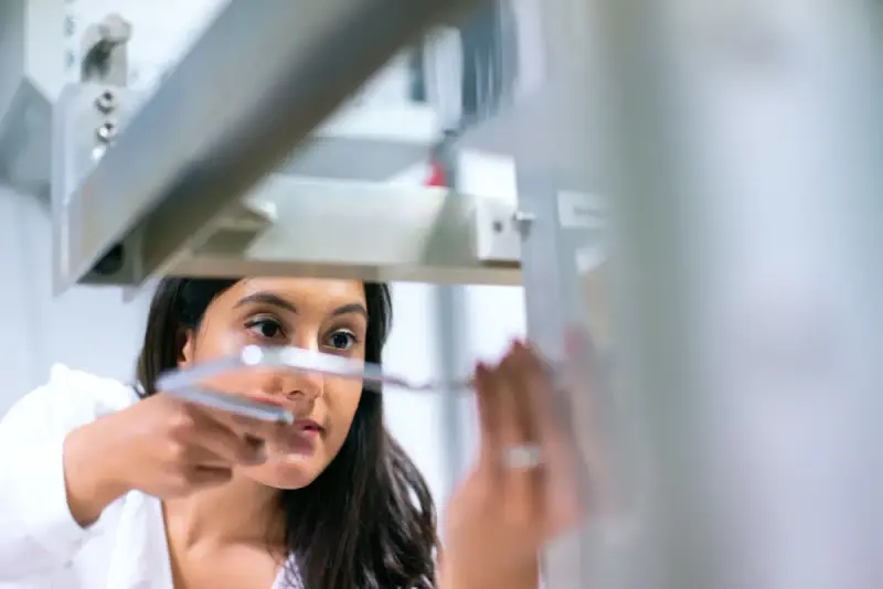 Female engineer concentrating on equipment in a modern laboratory