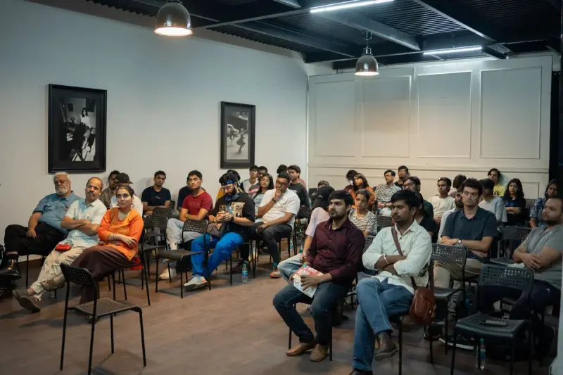 Audience seated in rows listening to a seminar in a loft-style room
