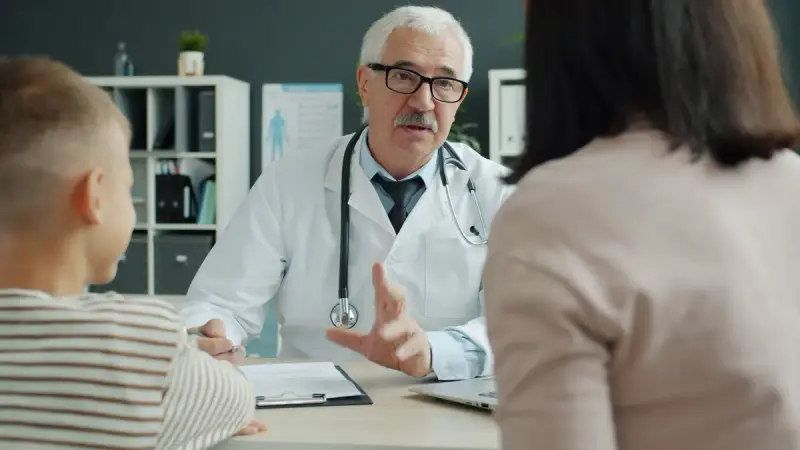 Doctor speaking with a family during a consultation in a medical office