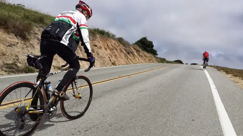 Road cyclist climbing a steep grade on the hilly road course at Sea Otter
