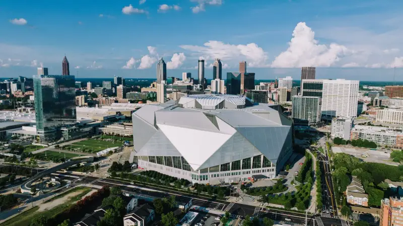 Aerial view of Mercedes-Benz Stadium and the Atlanta skyline on a clear day