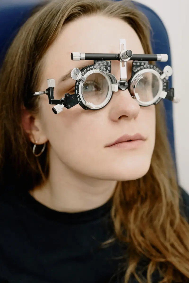 Woman wearing an optometry trial frame during an eye exam