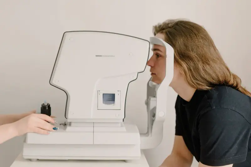 Woman taking a vision test on a modern ophthalmic screening device
