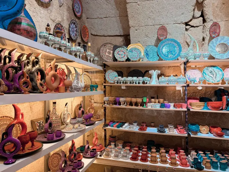 Colorful traditional ceramics displayed in a rustic stone interior