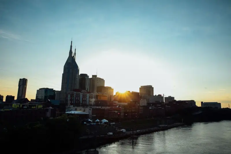 Nashville skyline at sunset reflected in the Cumberland River