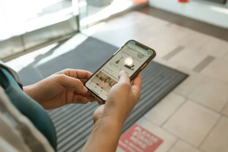 Hands holding a smartphone and browsing an online shopping app