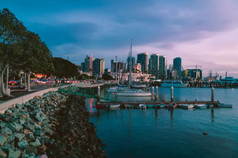 San Diego marina at twilight with docked boats and the downtown skyline