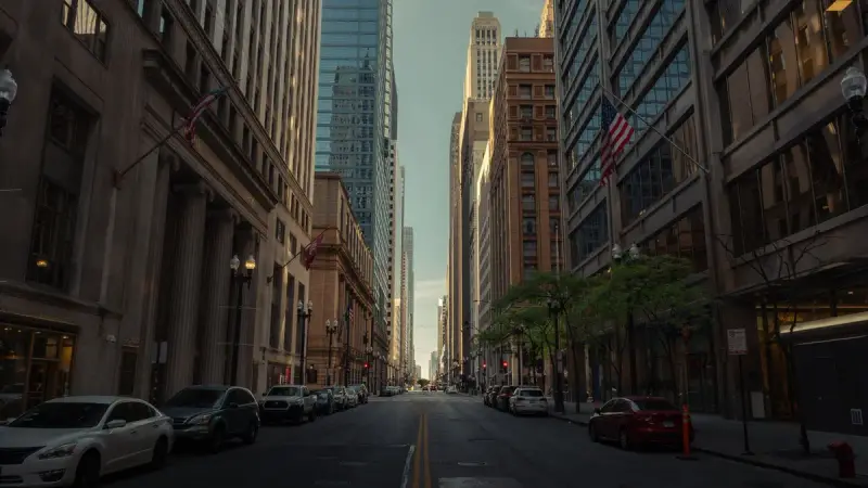 Downtown Chicago street lined with historic towers and skyscrapers in morning light