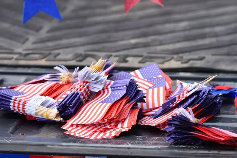 Bundles of small American flags piled on a pickup truck tailgate