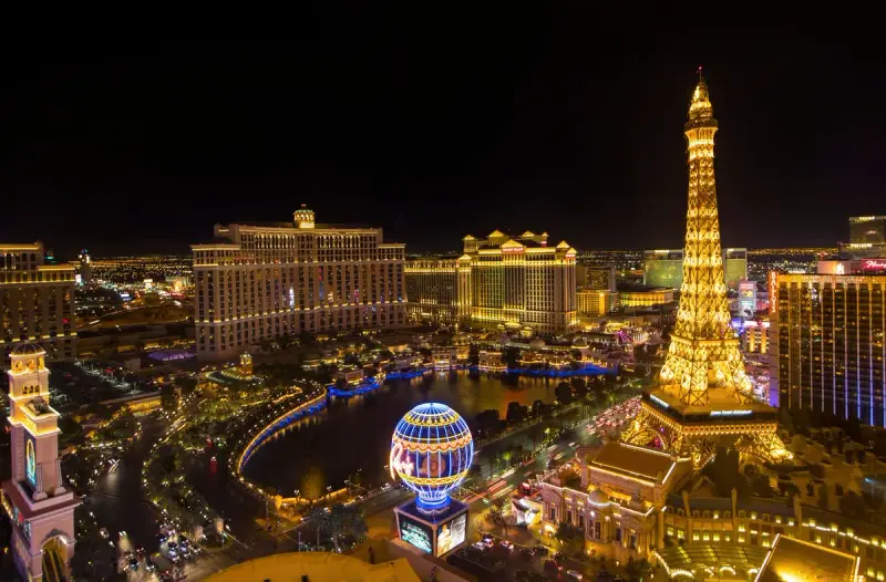Night aerial view of the Las Vegas Strip with the fountains and glowing resorts