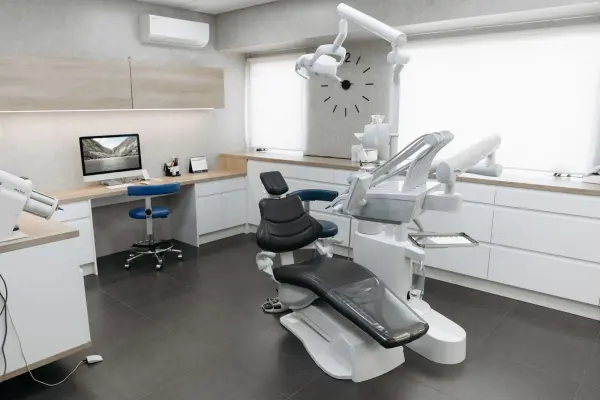 Modern dental clinic with a chair, monitor and equipment