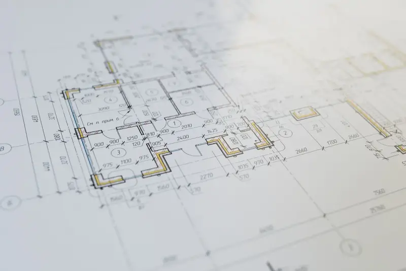 Macro view of a printed architectural floor plan with highlighted walls