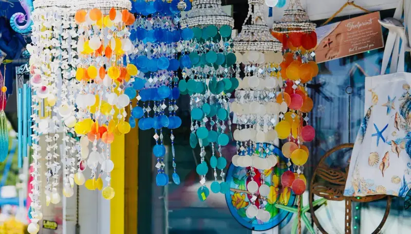 Hanging seashell wind chimes and beach decor in a souvenir shop