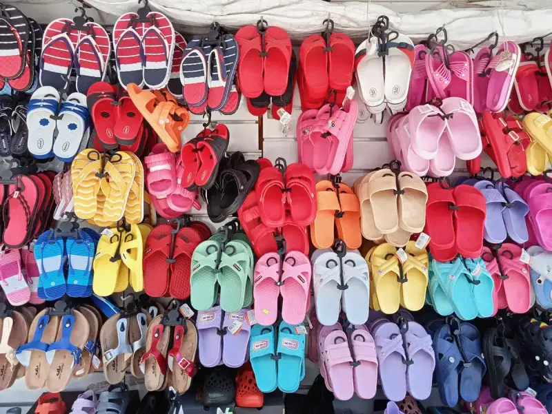Wall of colorful flip-flops and sandals hung for sale