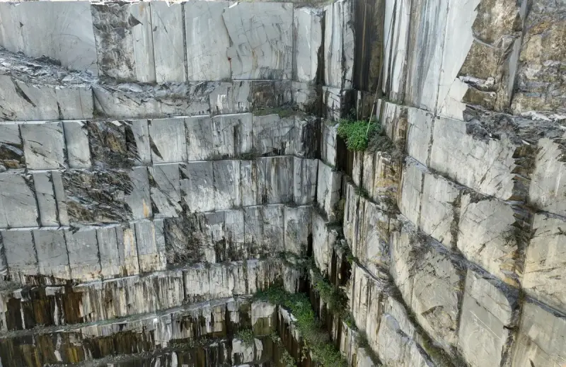 Aerial view of a granite quarry with scattered cut stone blocks