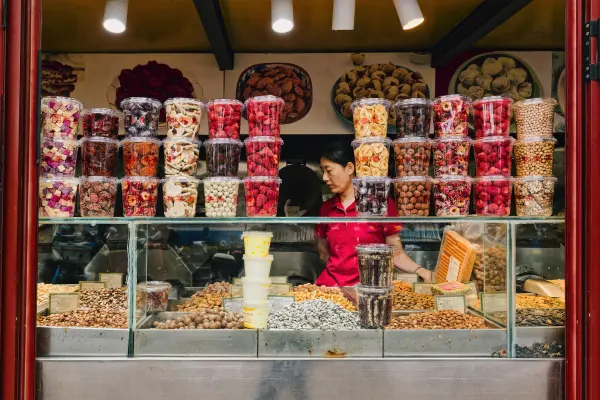 Rows of colorful sweets and snack products displayed in a candy shop