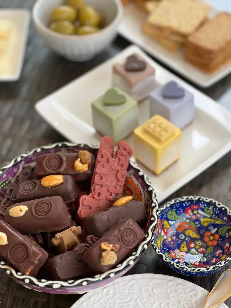 An assortment of chocolates and sweets arranged on serving dishes