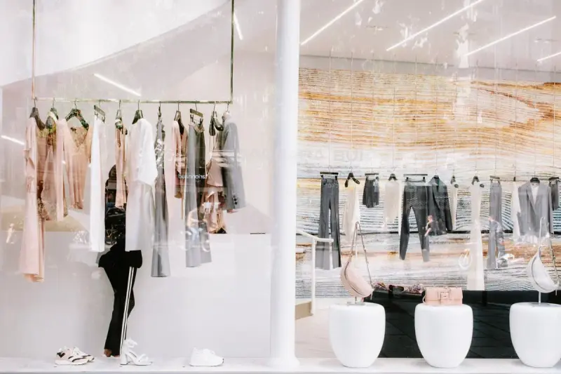 Clothing racks and reflections in a fashion store display