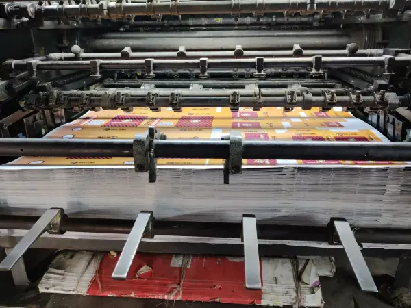 Paper sheets moving through an industrial printing machine