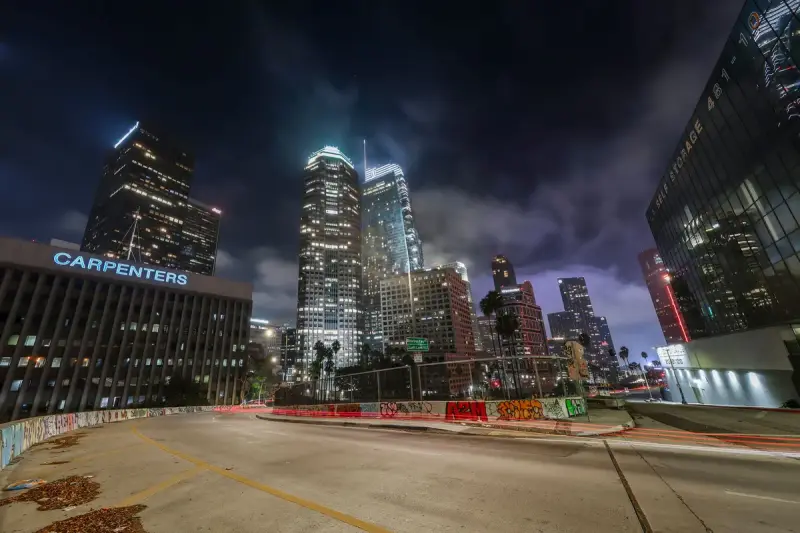 Downtown Los Angeles towers at night with traffic light trails