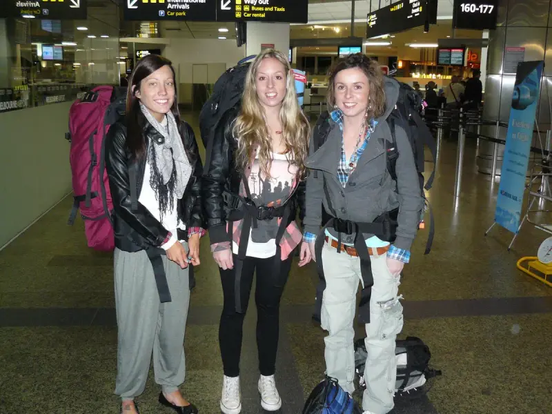 Three backpackers walking with loaded packs