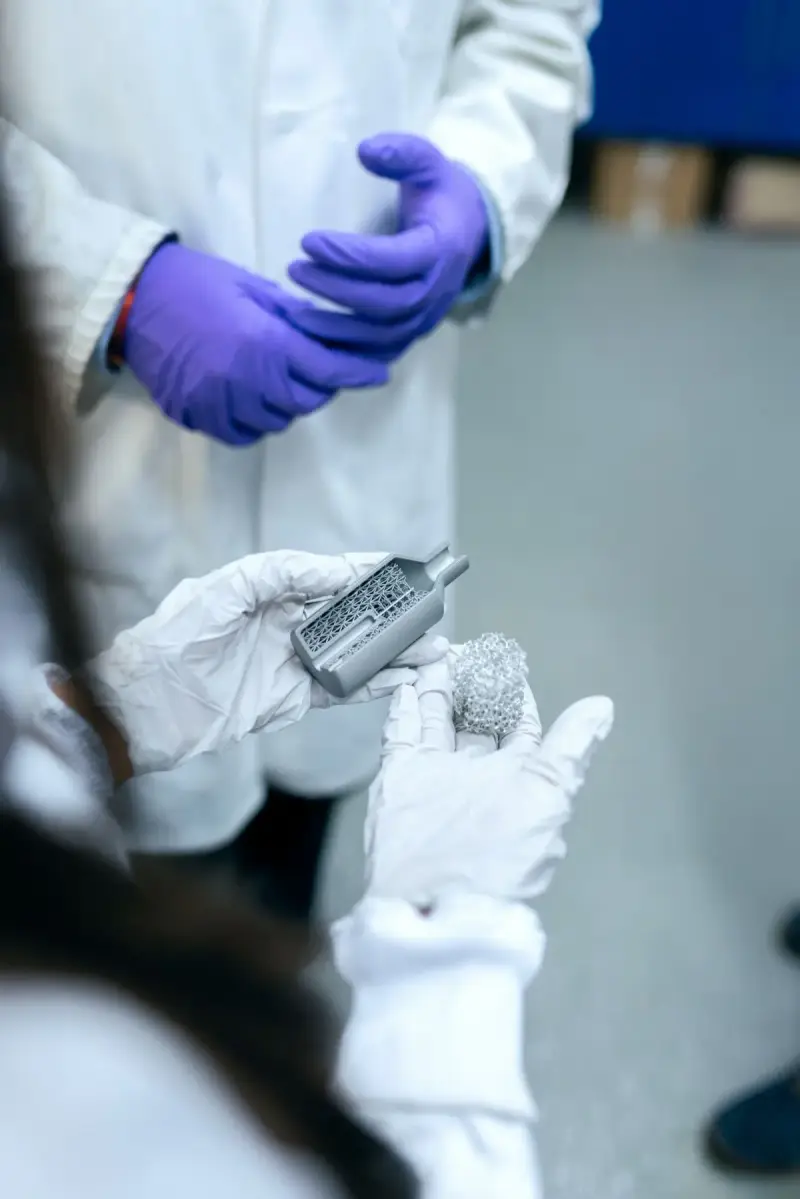Researchers examine a material sample in a laboratory. Materials-engineering reference photograph.
