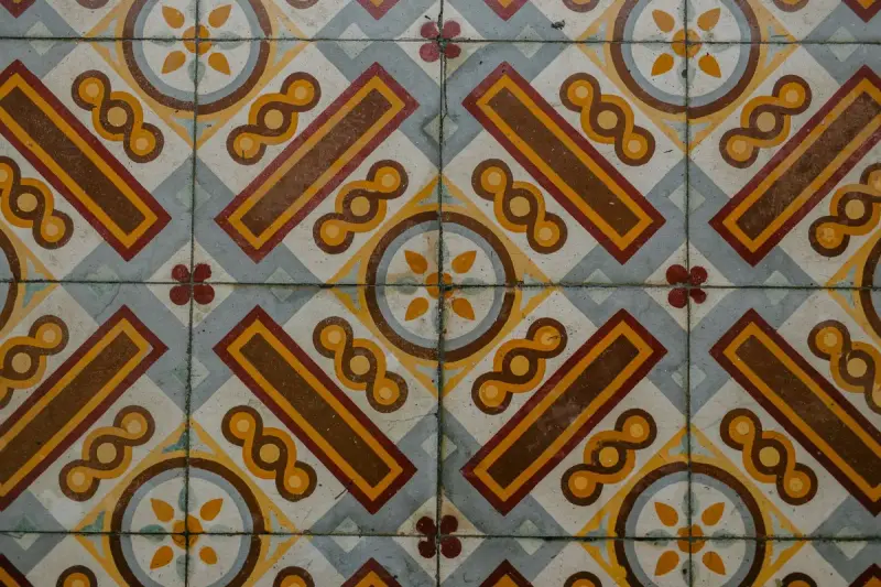 Patterned cement tile floor in blue, brown and gold