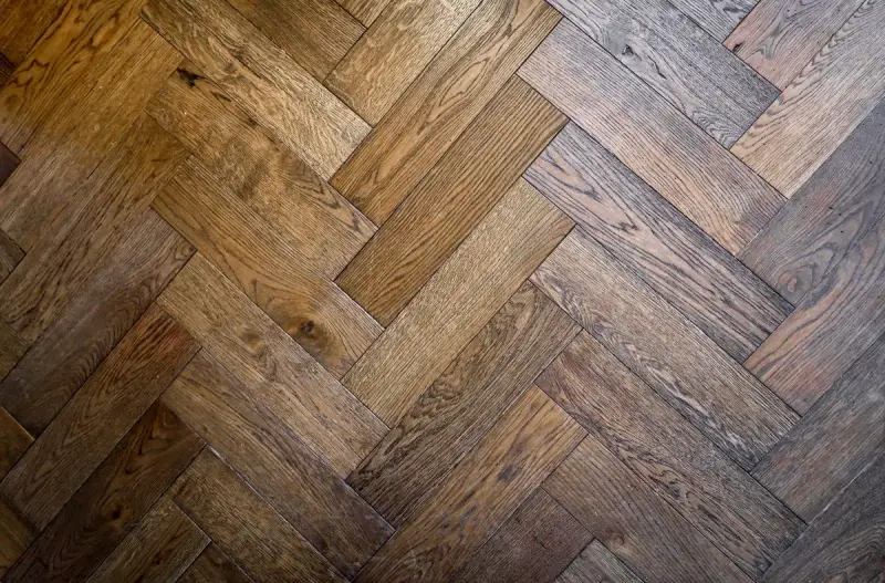 Herringbone parquet floor in warm oak tones seen from above