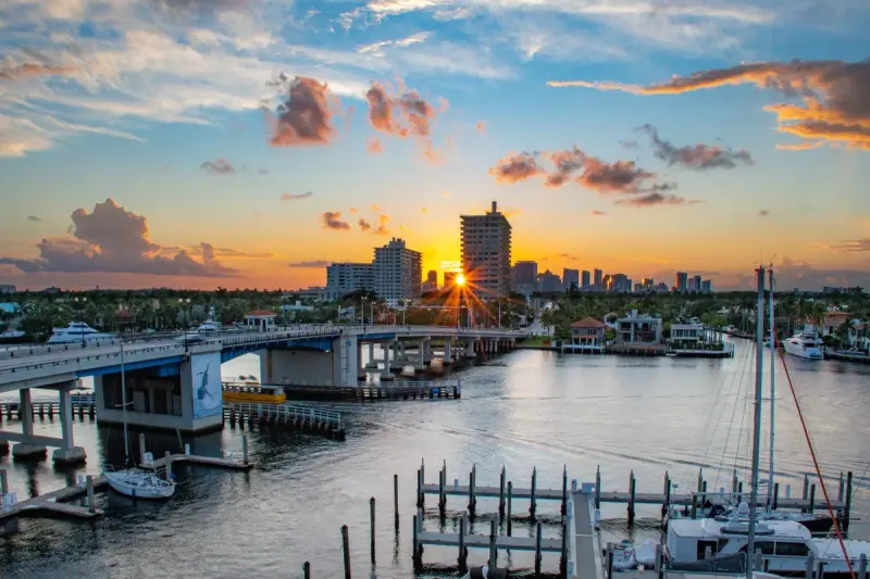 Sunrise over the Las Olas bridge and marina with the Fort Lauderdale skyline behind