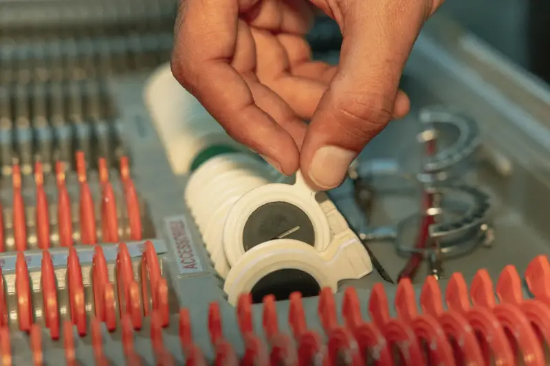 Optometrist choosing a trial lens from a fitting kit