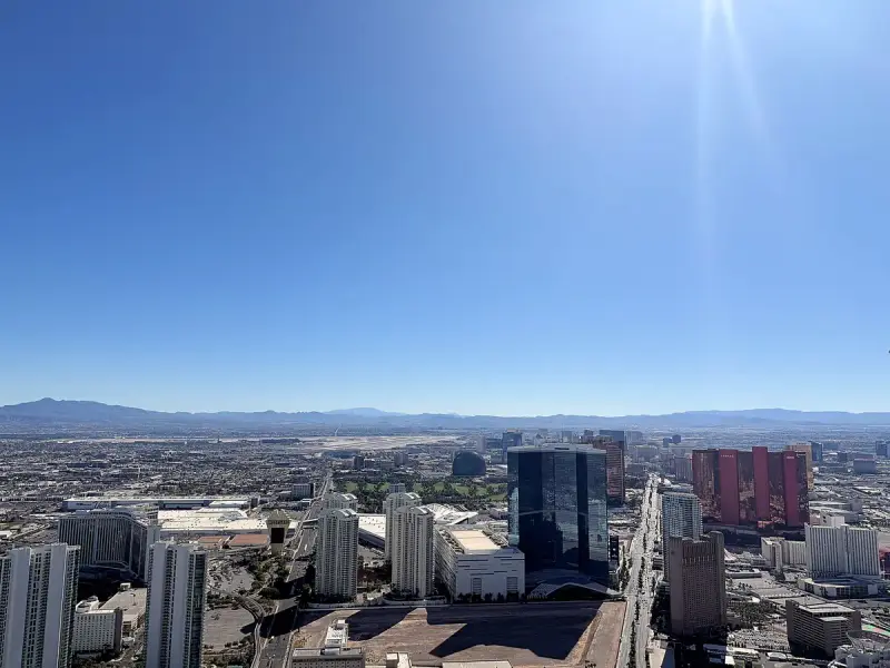 Daytime view over Las Vegas high-rises toward the desert mountains from a high observation deck
